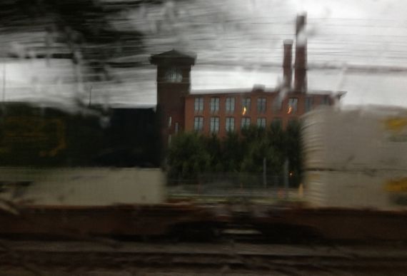 Train in rain through window